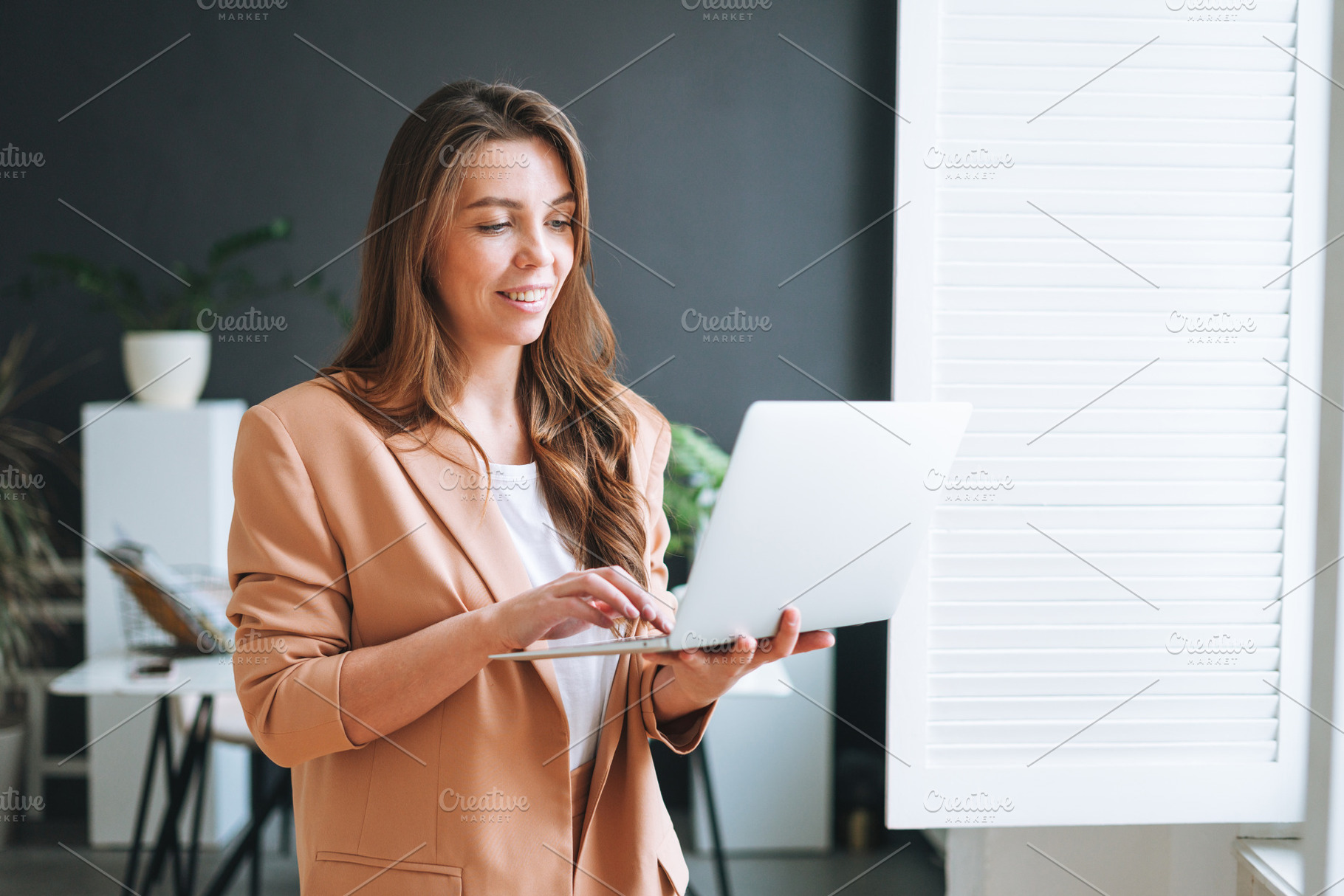 Young businesswoman near window, a Business Photo by Galina_Zhigalova