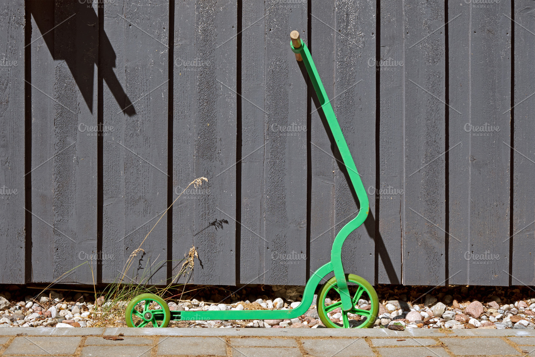 Kick scooter against wooden wall, a Transportation Photo by BOOCYS