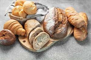 Fresh baked assorted breads and pastries on table, a Food & Drink Photo by Olena Rudo