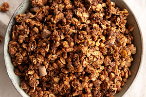 Homemade Healthy Chocolate Granola in a Bowl, top view., a Food & Drink Photo by LiudmylaChuhunova
