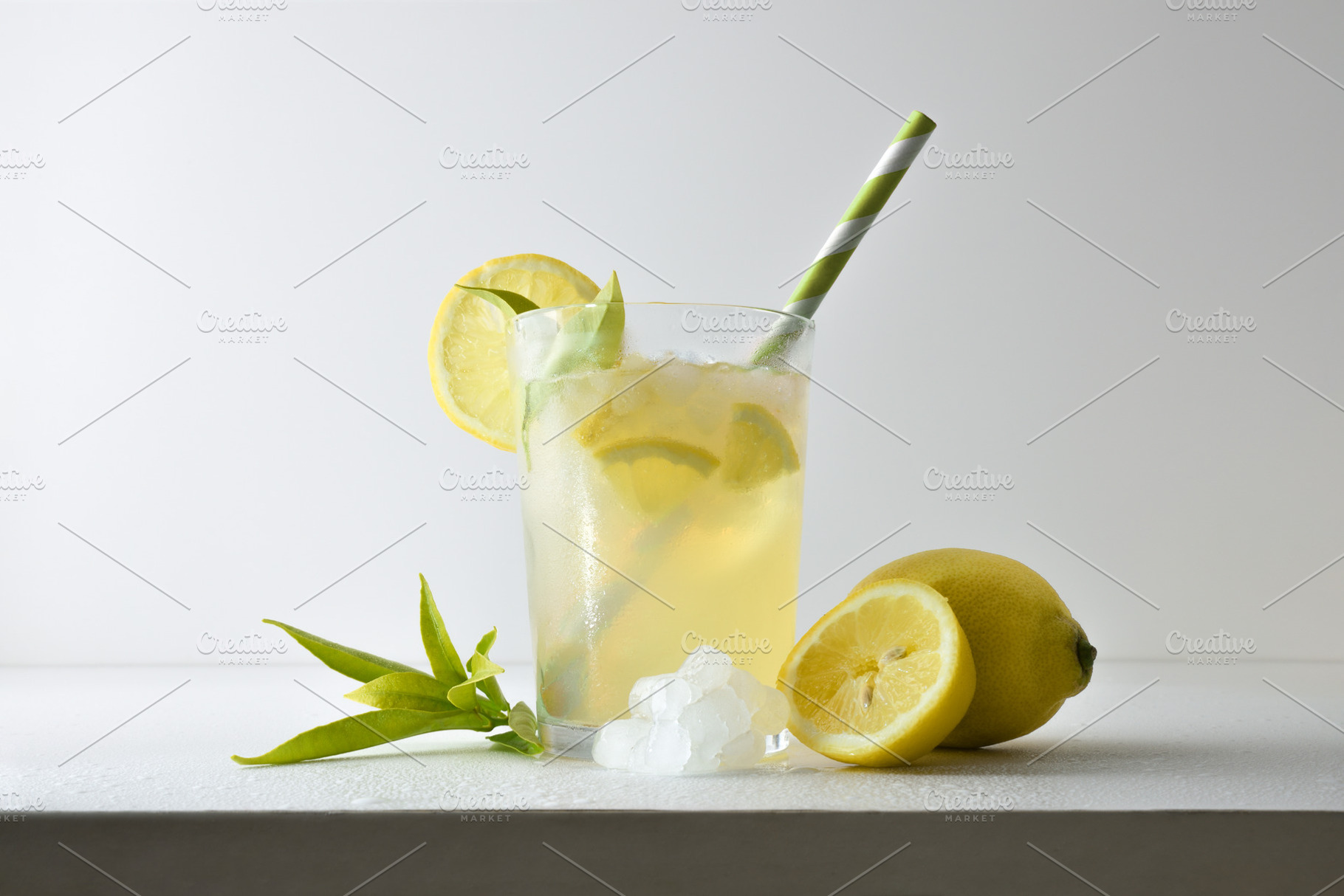 Refreshing lemon drink with ice on a white isolated background, a Food & Drink Photo by Davizro's Market