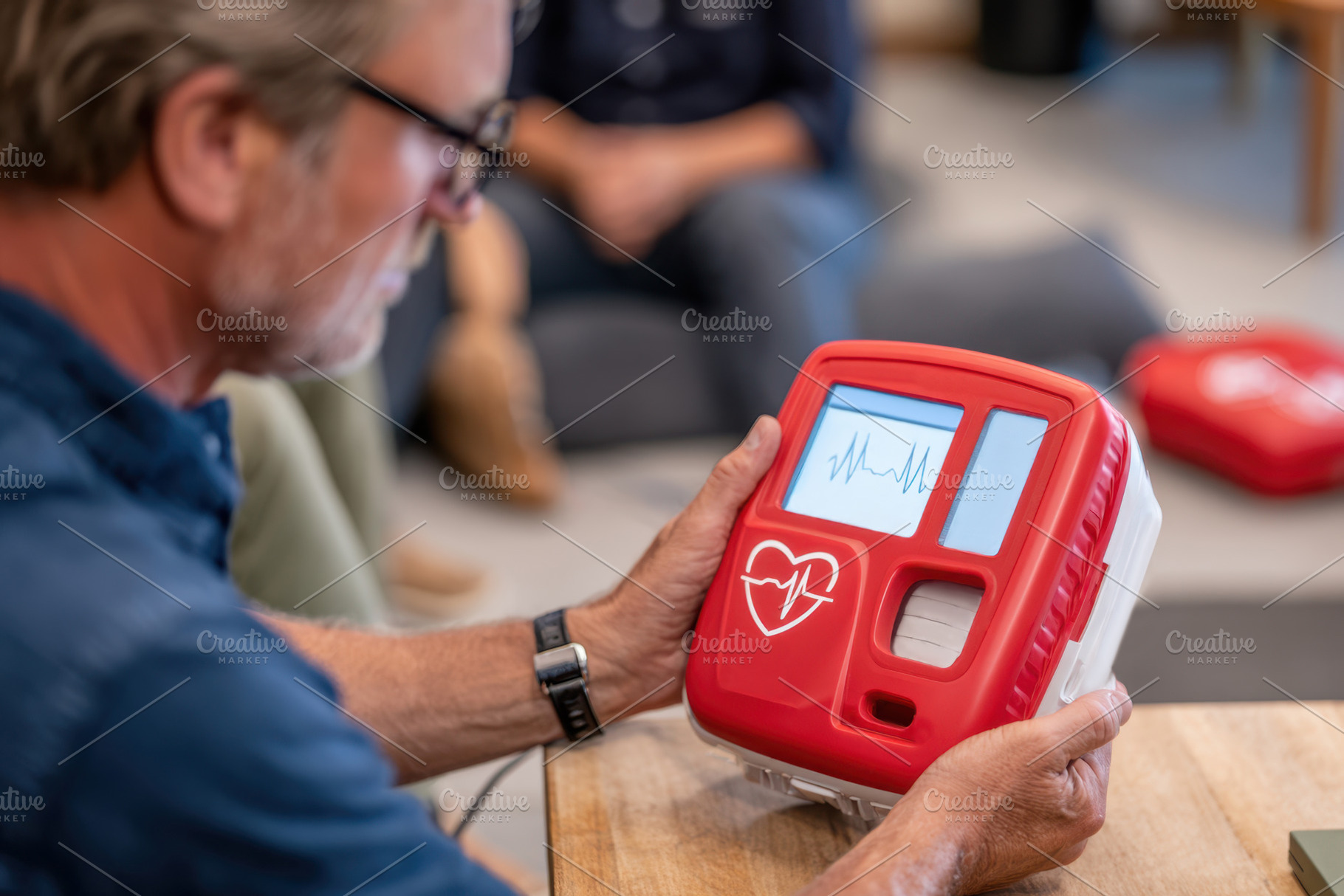 Person using an automated external defibrillator, a Health & Medical Photo by AlyaAnd