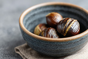 Roasted chestnuts in a rustic bowl, a Food & Drink Photo by MistyDay