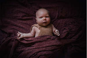 Newborn baby lying peacefully in, a Person Photo by HalfPoint