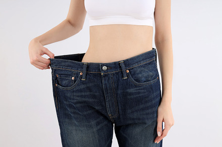 Concept of weight loss with thin girl on light background, a Person Photo by AtlasStudio