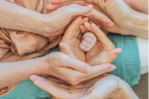 Newborn tiny hand surrounded by, a Person Photo by Elizaveta Galitskaya