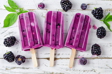 Ice cream popsicles with organic blueberries on wooden background, a Food & Drink Photo by AlyaAnd