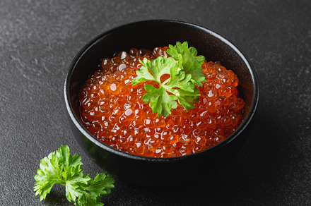 Salmon caviar with parsley in a bowl