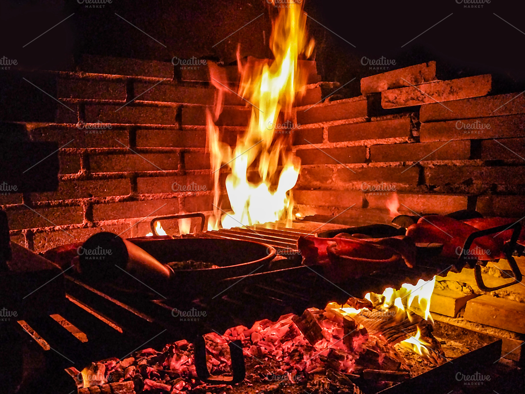 Barbecue fire cooking meat at night, a Food & Drink Photo by DanFLCreativo