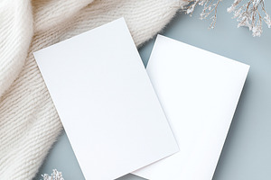 Two blank cards mockup on cozy white knit sweater with frosted branches, flat l, a Holiday Photo by Studio ANNA