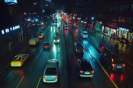 Busy city road illuminated at night, a Photo by Iftikhar Alam