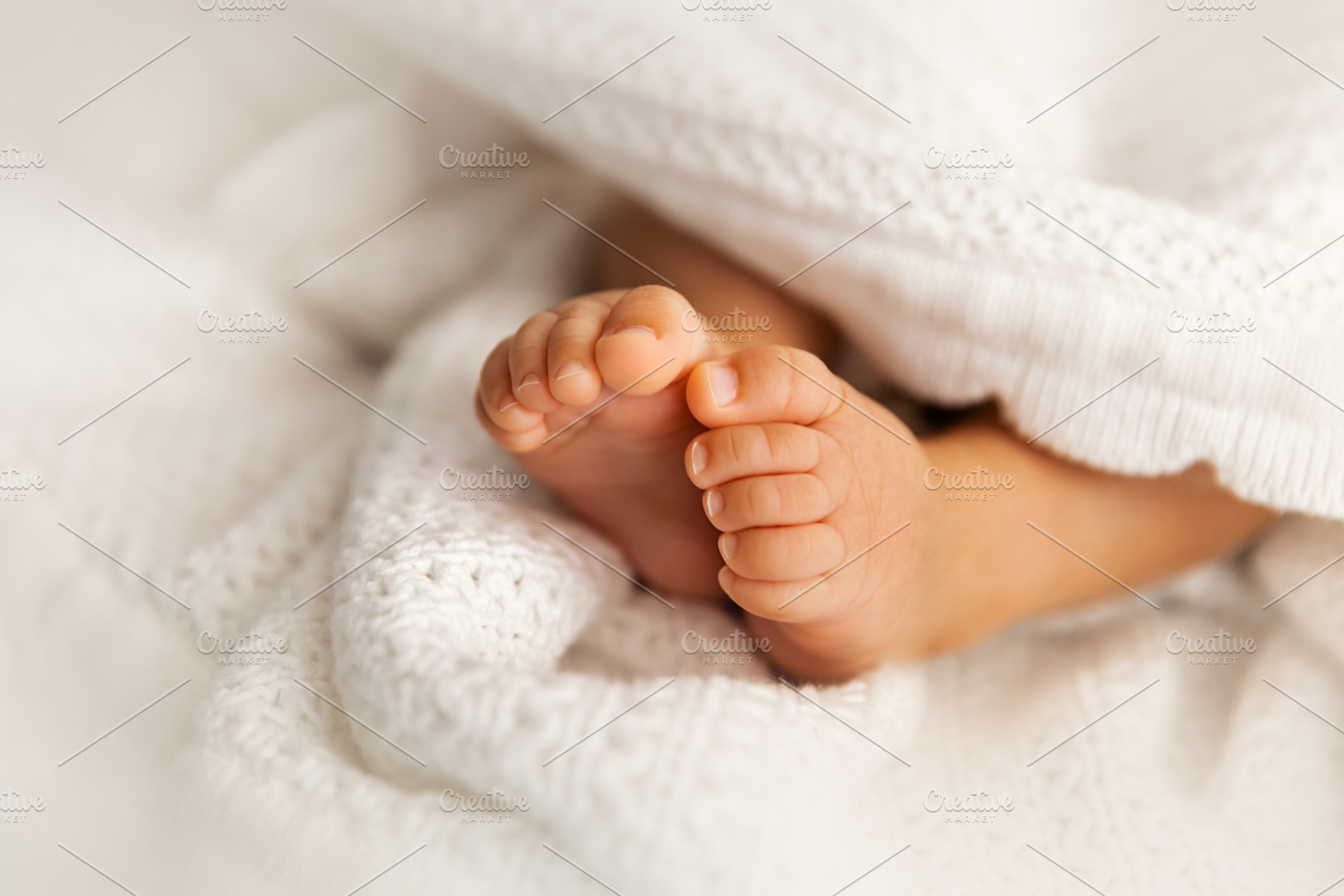 Newborn baby feet under blanket, a Person Photo by PhotographerJen