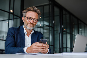 Businessman using smartphone in mode, a Photo by Pixeness Studio