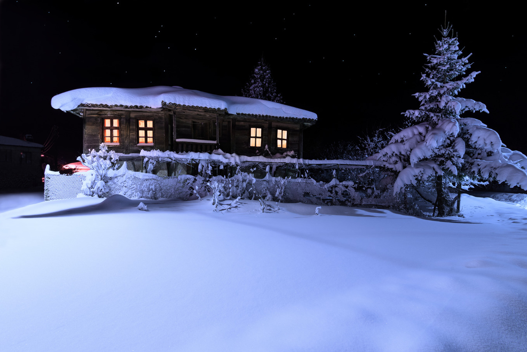 Old wooden house with a light in the, a Holiday Photo by Milen Dobrev