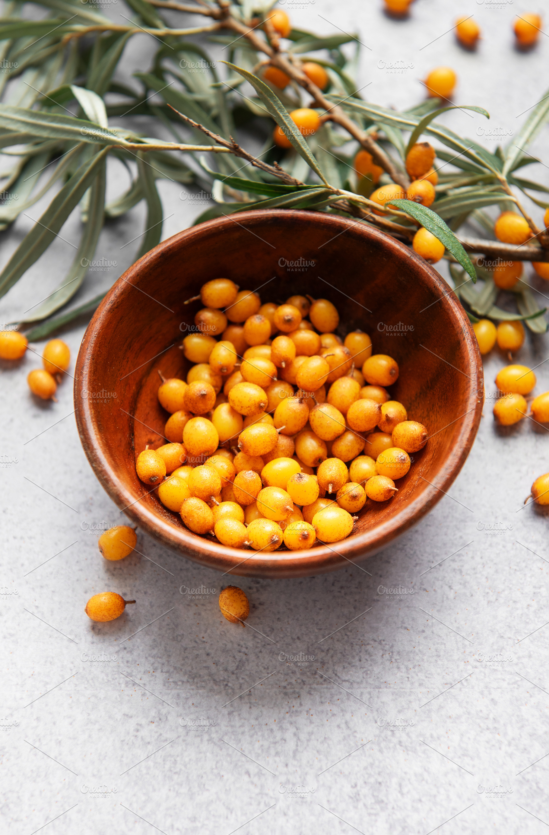 Sea buckthorn berries in bowl, harvesting healthy superfood, a Food & Drink Photo by Olena Rudo