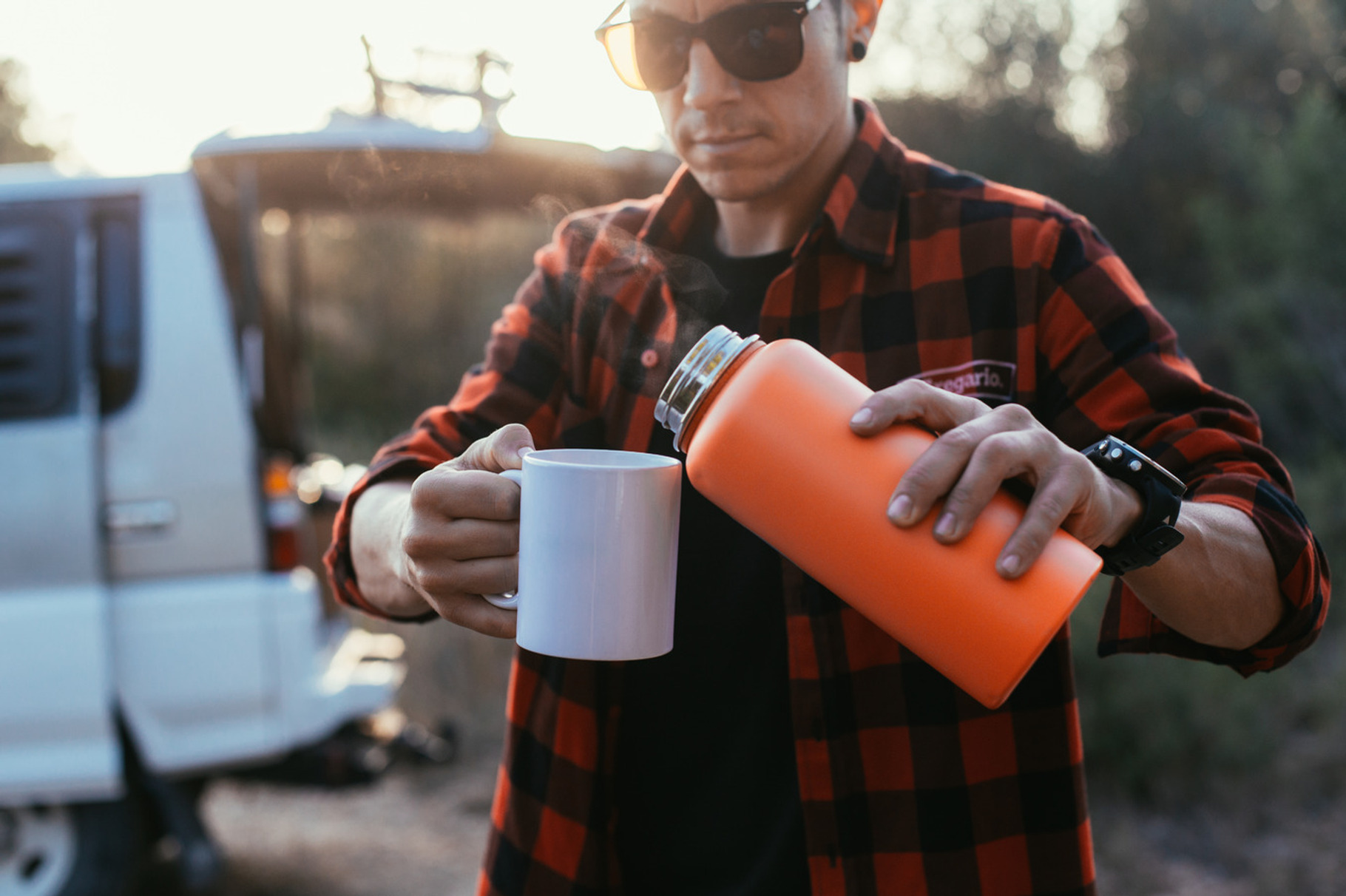 Man pours hot coffee from thermos, a Food & Drink Photo by DeRepente