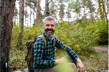 Handsome man sitting on rock in the, a Sports & Recreation Photo by HalfPoint