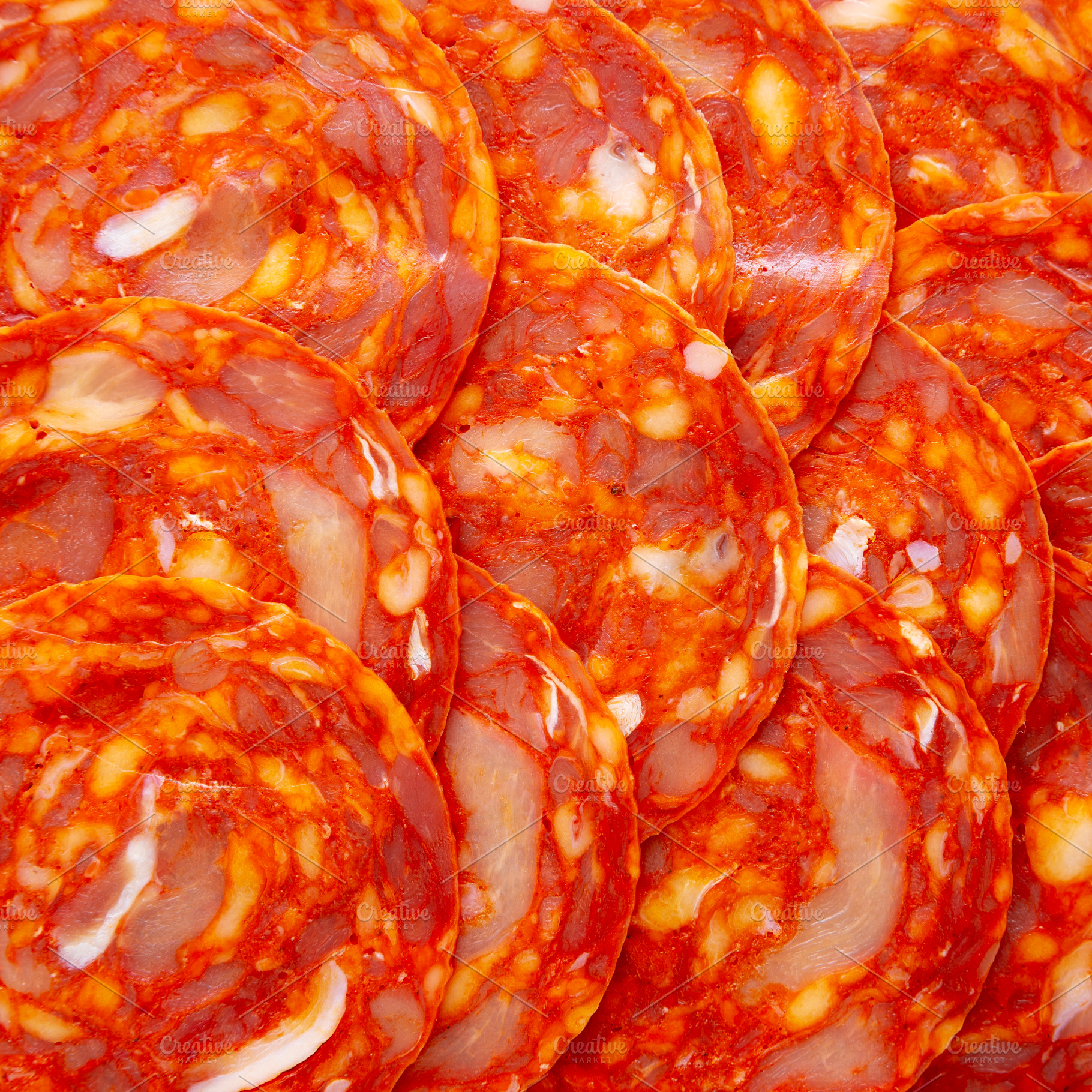 Cold Meat Chorizo Slices on a Wooden Board, top view. Close-up., a Food & Drink Photo by LiudmylaChuhunova