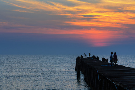 Sea at sunrise containing sunrise, sea, and bridge, a Nature Photo by yongkiet jitwattanatam