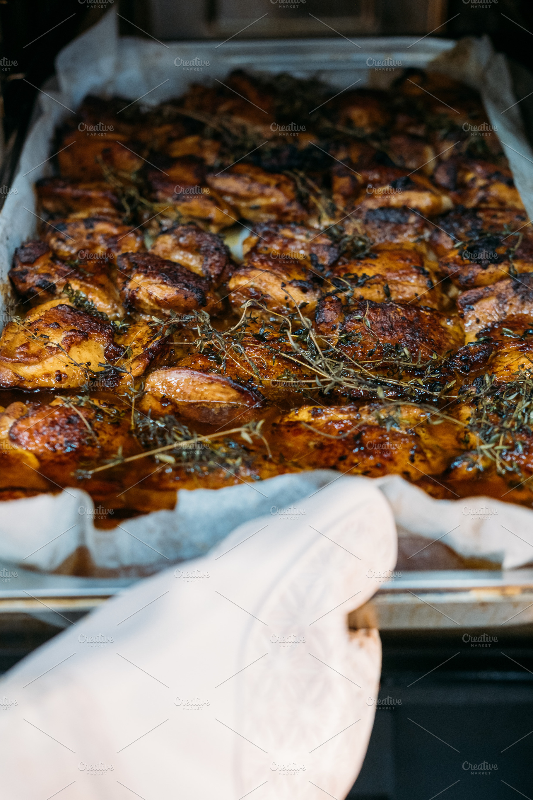 Meal cooking roasting meat hand baking tray herbs, a Food & Drink Photo by Photo Drive Studio