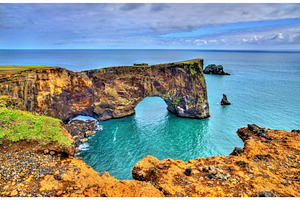 Natural arch of dyrholaey peninsula iceland containing iceland, basalt, and, a Nature Photo by Leonid Andronov