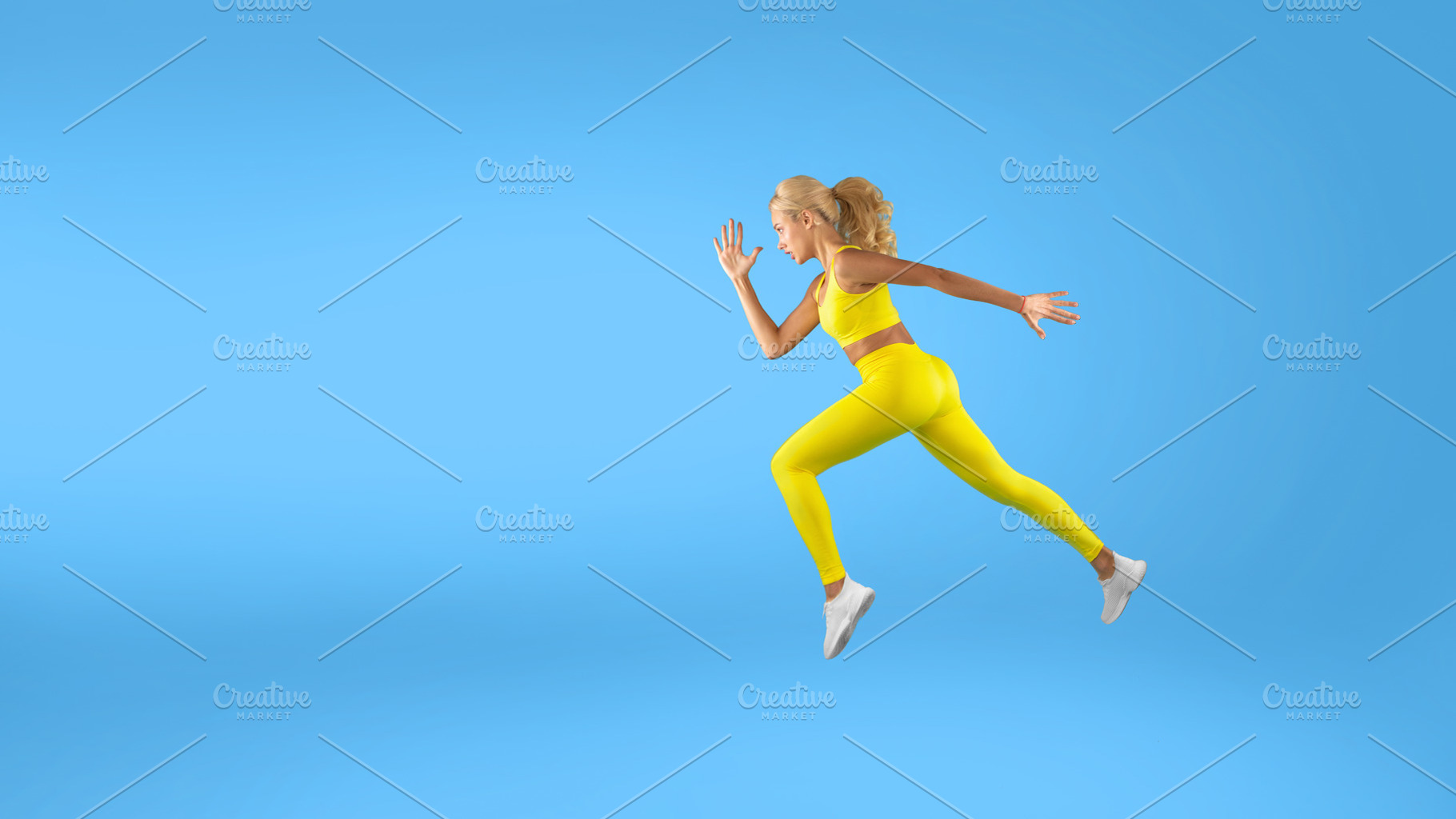 Serious woman running at blue studio background, a Photo by Prostock-Studio