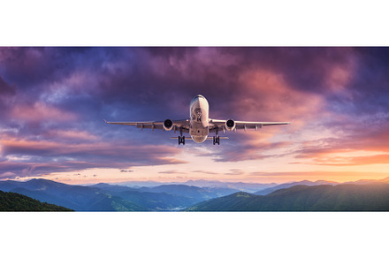 Plane is flying in colorful sky at, a Transportation Photo by den-belitsky
