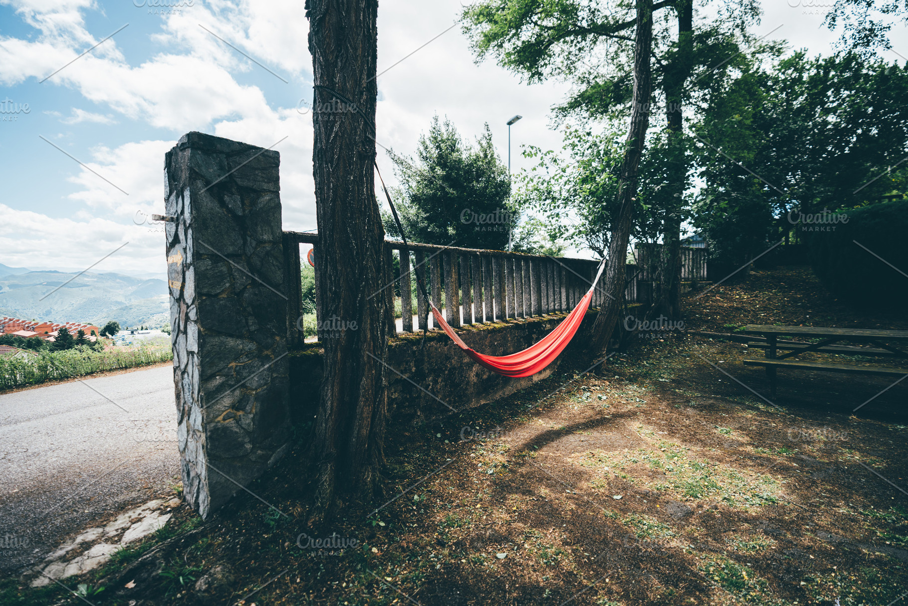 Red hammock between trees outdoors, a Sports & Recreation Photo by SkyNext