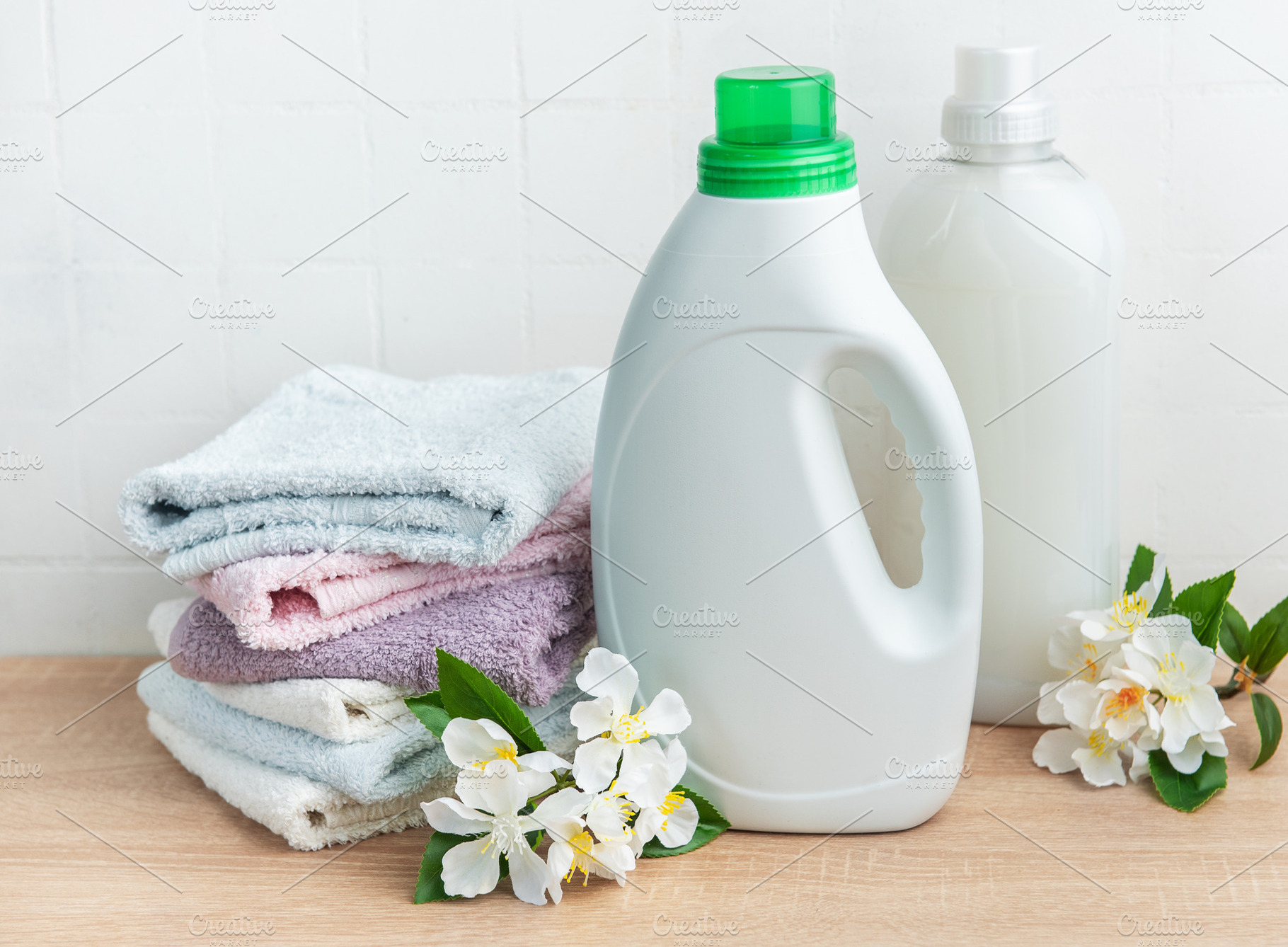 Detergent and fabric softener with fresh laundry towels and flow, an Industrial Photo by Olena Rudo