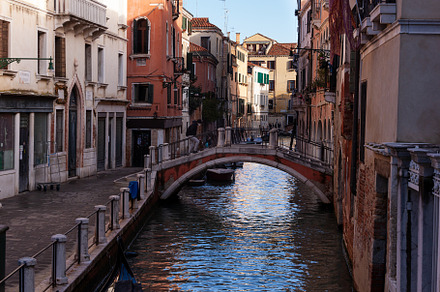 The old bridge made with red bricks on the typical canal in Venice, an Architecture Photo by Bepslabor