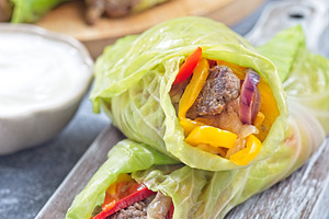 Beef and vegetable cabbage leaves wraps, served with plain yogurt, vertical, a Food & Drink Photo by iuliia_n