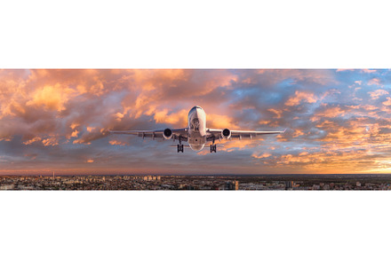 Airplane is flying in colorful sky, a Transportation Photo by den-belitsky
