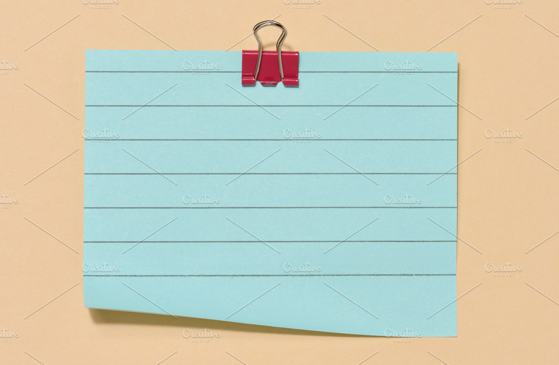 Blue sticky note secured with a red paper clip, centered on a be, a Beauty & Fashion Photo by ndanko