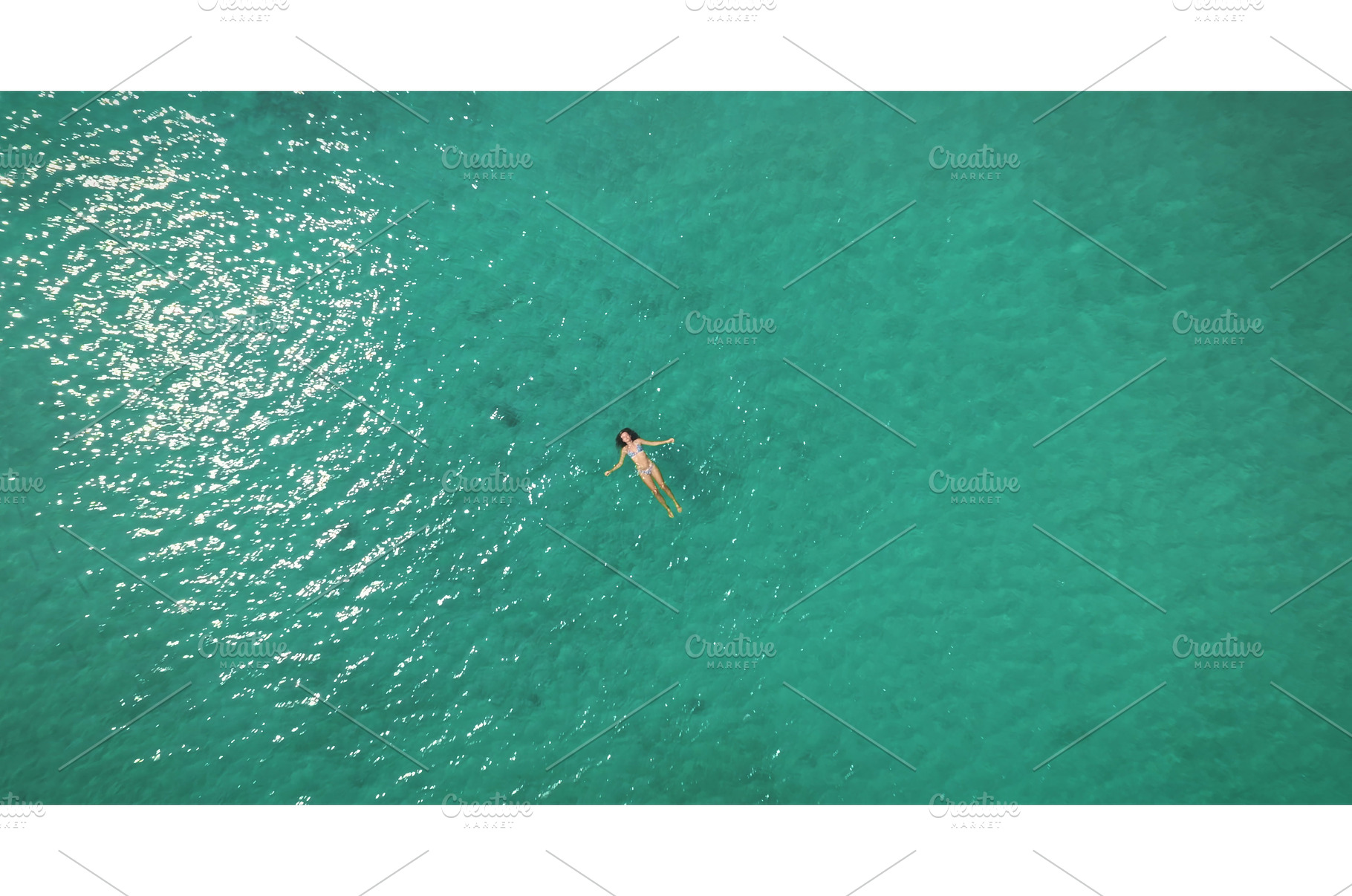 Woman floating in clear turquoise, a Person Photo by Goinyk