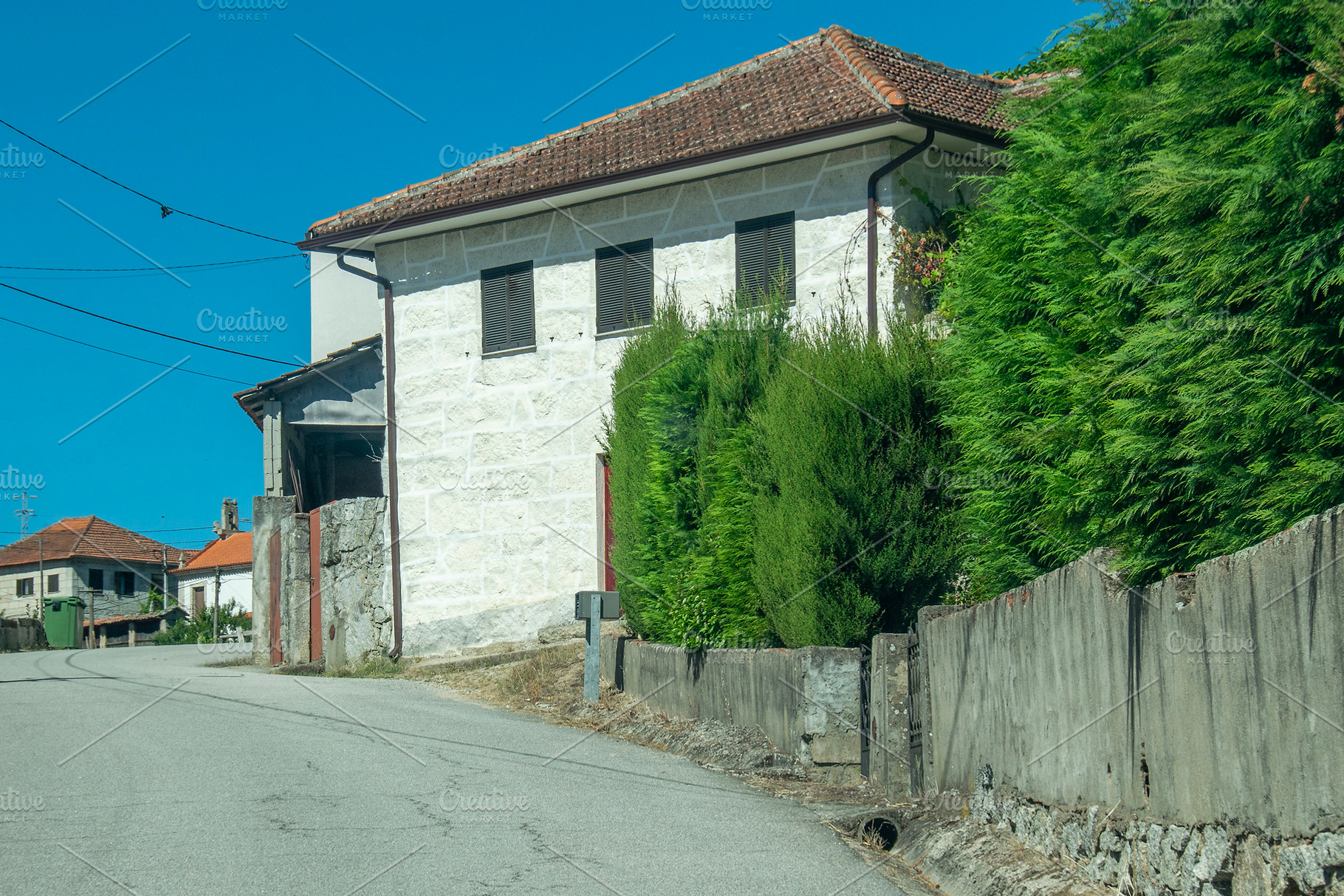 Narrow street between stone and whitewashed houses, a Transportation Photo by DanFLCreativo