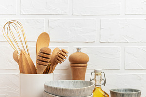 Kitchen utensils, bowls and ingredients resting on wooden counte, a Food & Drink Photo by Olena Rudo