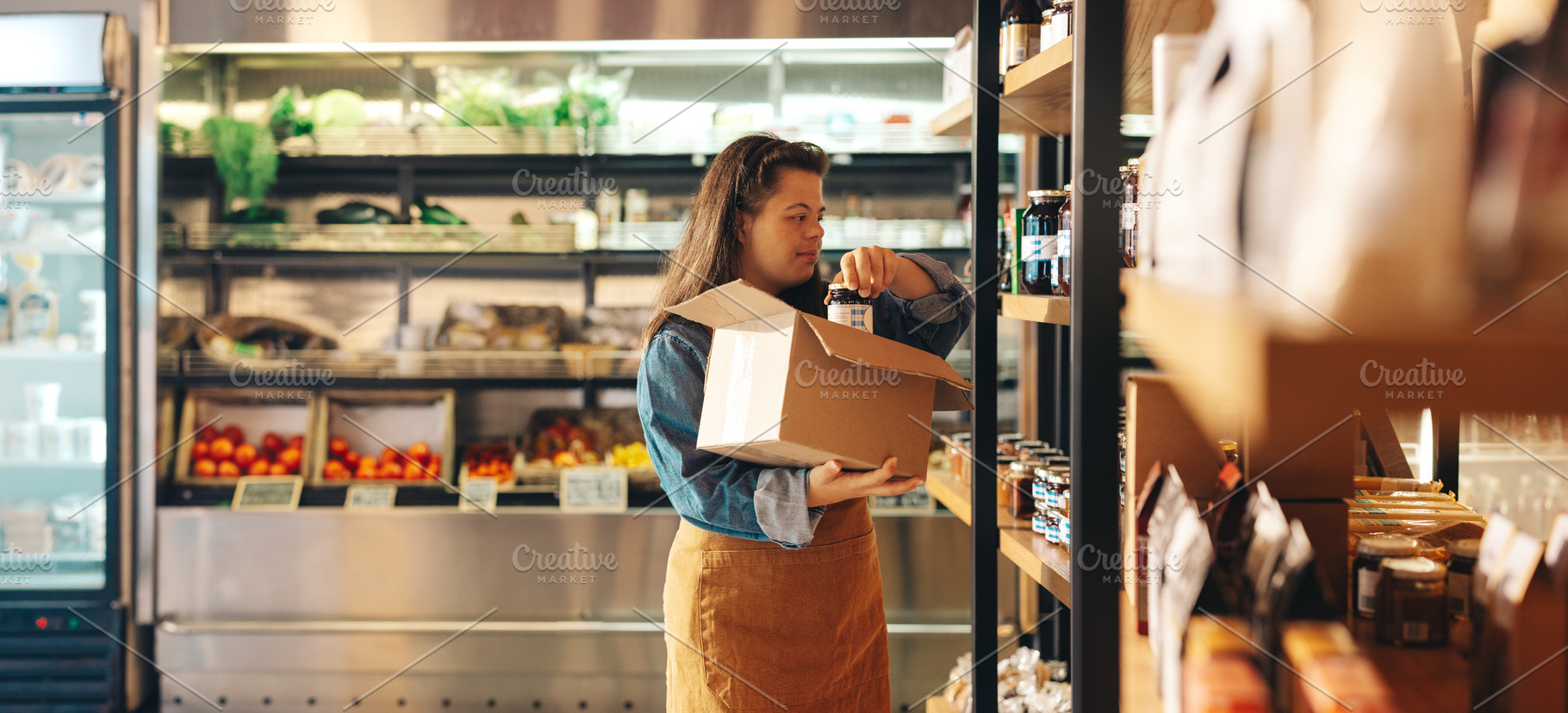 Supermarket worker with Down syndrome restocking food products, a Person Photo by Jacob Lund