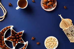 Ramadan Kareem concept. Flat lay tray of dates fruit, wooden lantern in form of