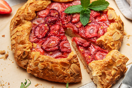 Delicious homemade strawberry galette with almond petals baking