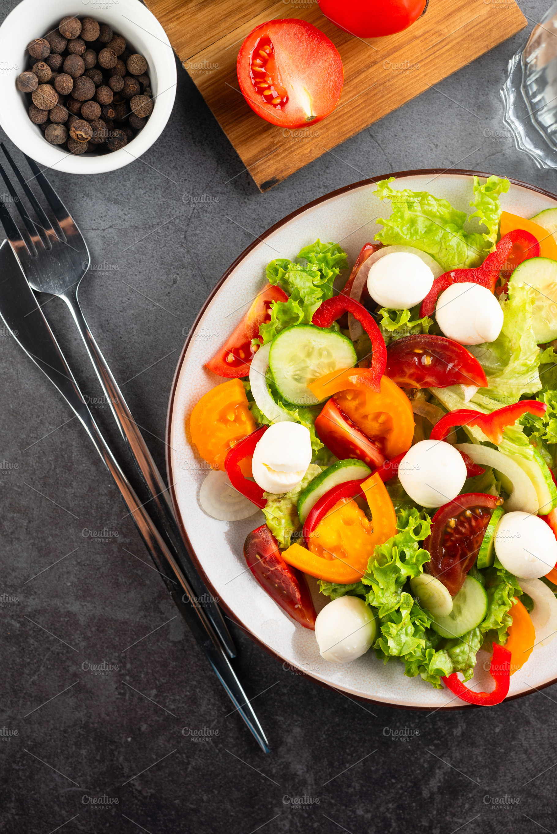 salad with red and yellow tomatoes, peper, cucumbers, lettuce an, a Food & Drink Photo by vimart