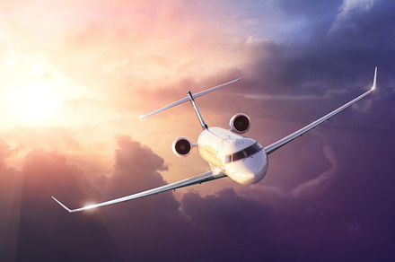 Airplane in sunset sky