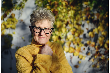 Senior woman standing outdoors, a Nature Photo by HalfPoint