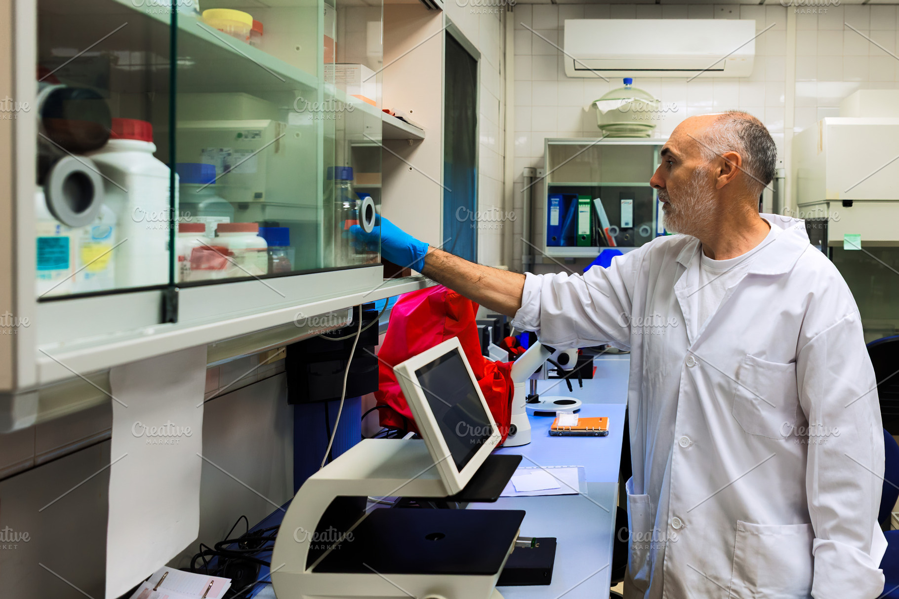 Scientist in a laboratory accessing, a Health & Medical Photo by Perpis