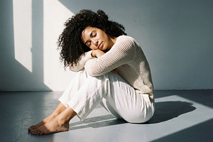 Serene Young Woman with Curly Hair, a Person Photo by Virgo Studio