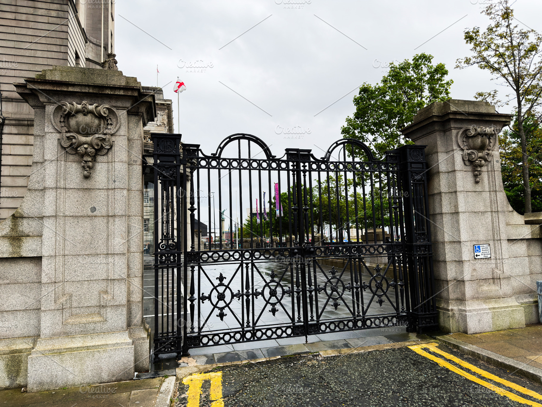 Ornate wrought iron gate and stone entrance to civic building in, a Photo by AS photostudio