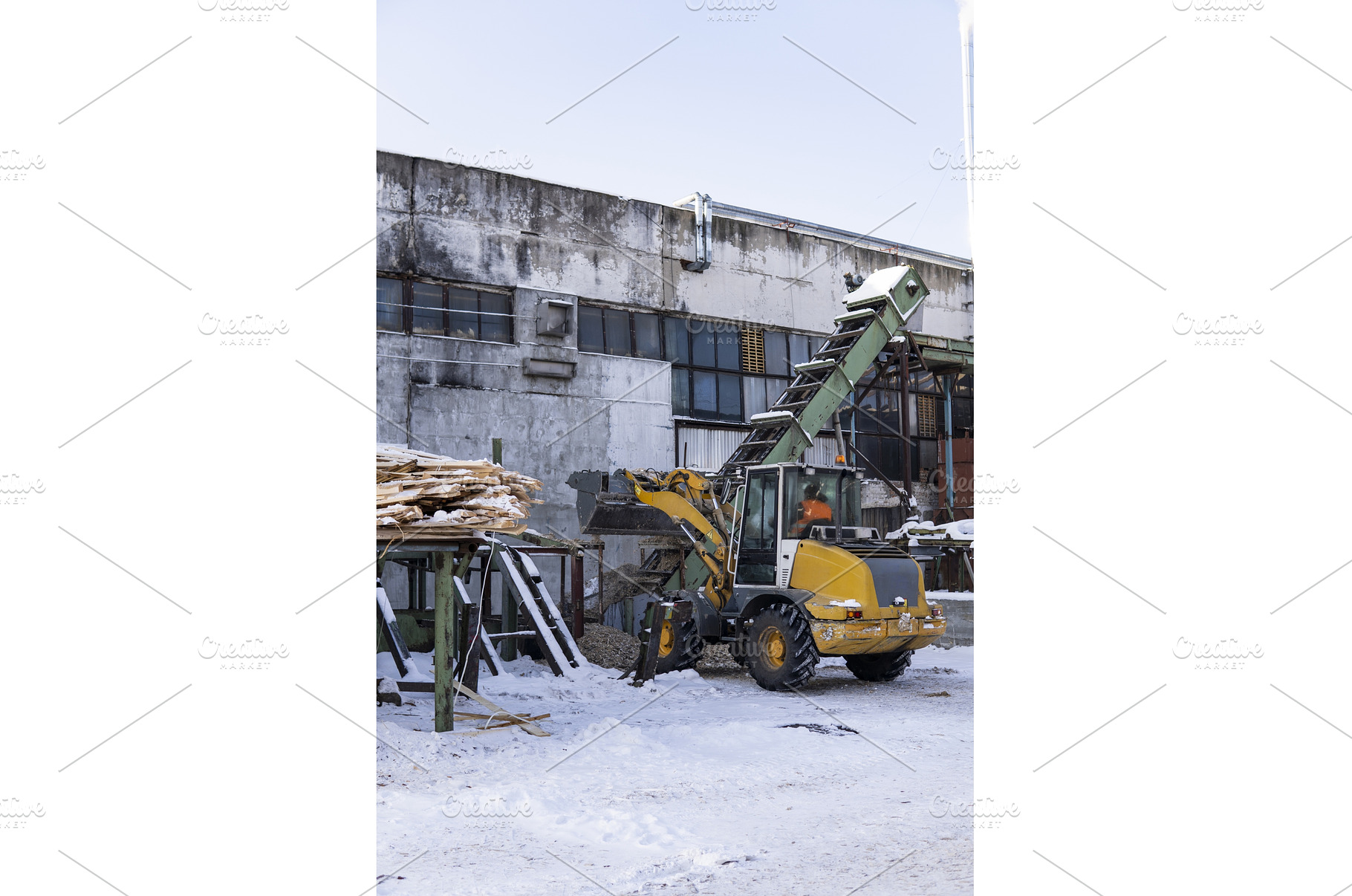 Loader moving wood chips using a, an Industrial Photo by volodymyrshtun13795