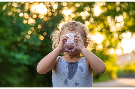 A child drinks water from a glass, a Person Photo by yanadjana