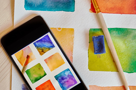smartphone on arts hand drawn background with artist supplies