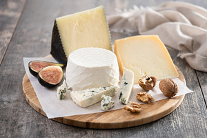 Board of different cheeses with nuts, figs, grapes and wine, a Food & Drink Photo by etorres69