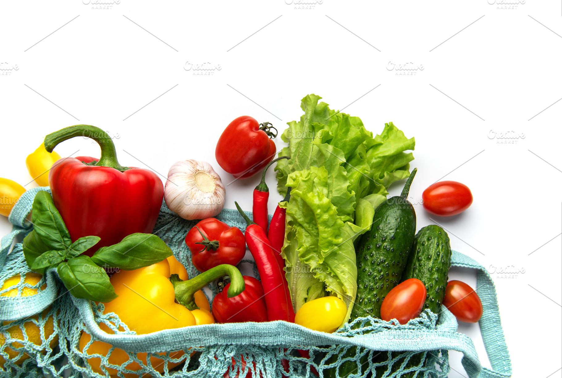 Fresh organic vegetables in reusable shopping bag on white, a Food & Drink Photo by Olena Rudo